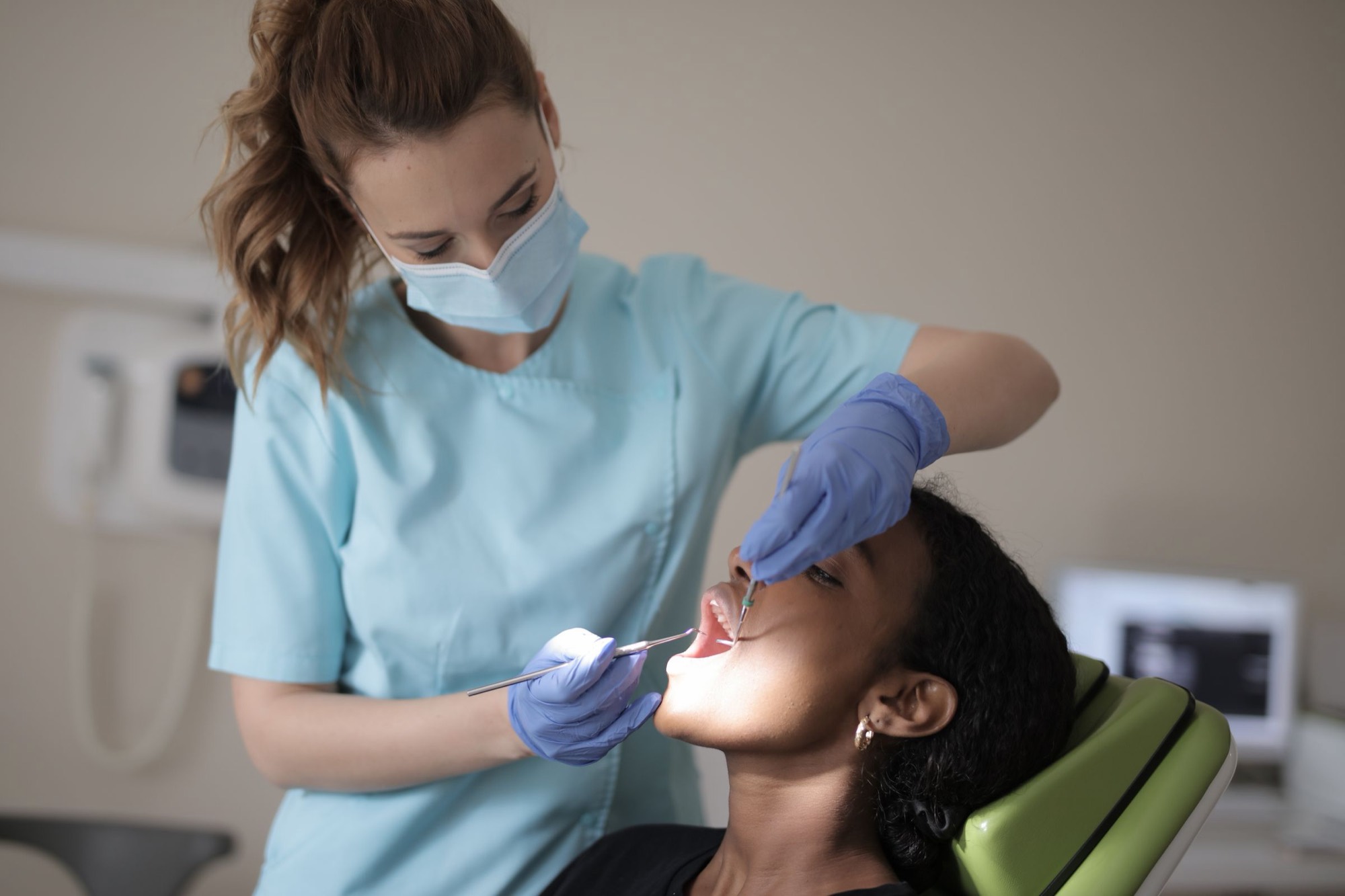 A dental clinician examining a patient